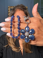 18-inch faceted blue sapphire necklace with large sapphire flower pendant and diamond clasp. A striking Ulka Rocks design in sterling silver.
