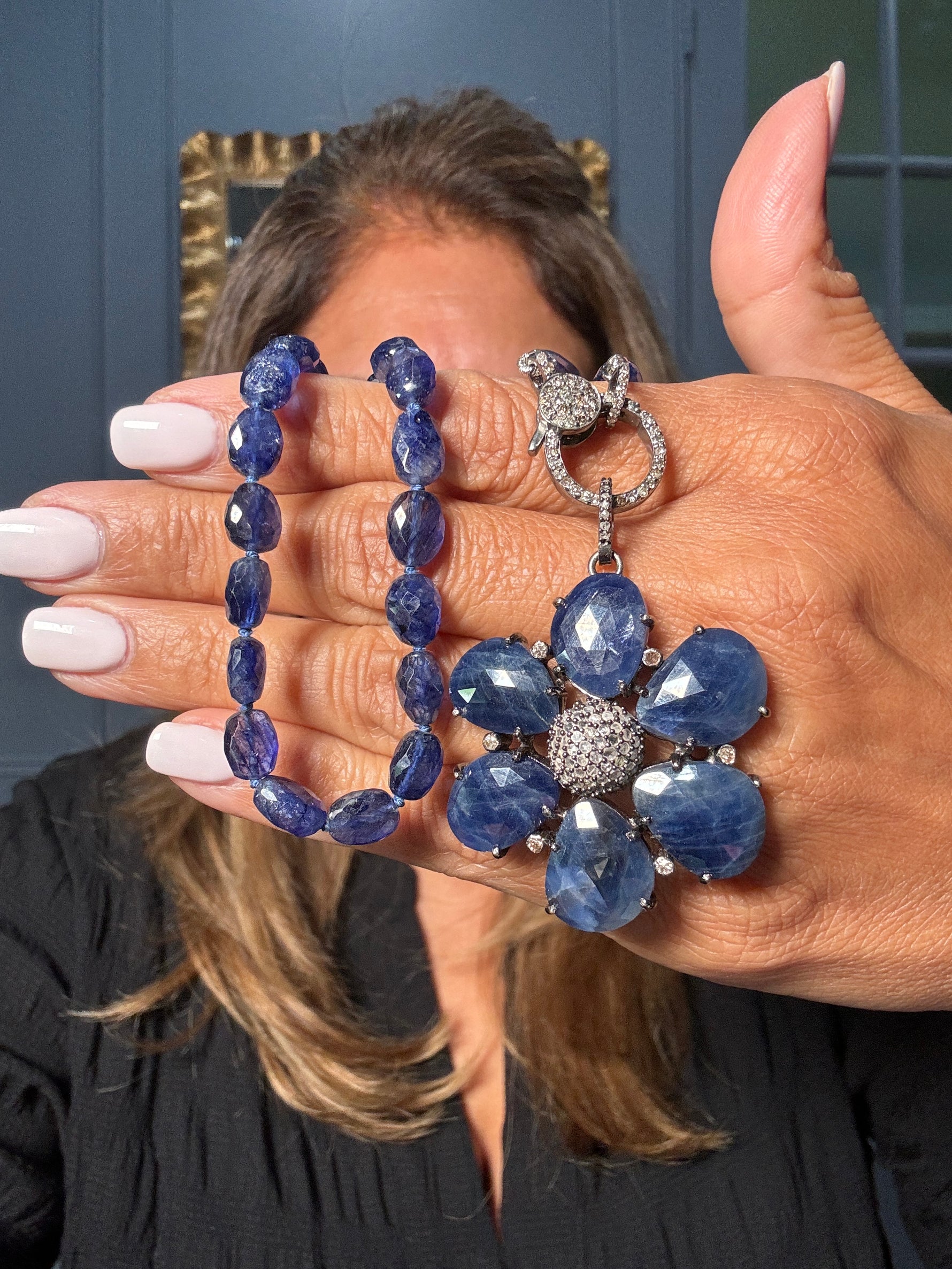 18-inch faceted blue sapphire necklace with large sapphire flower pendant and diamond clasp. A striking Ulka Rocks design in sterling silver.