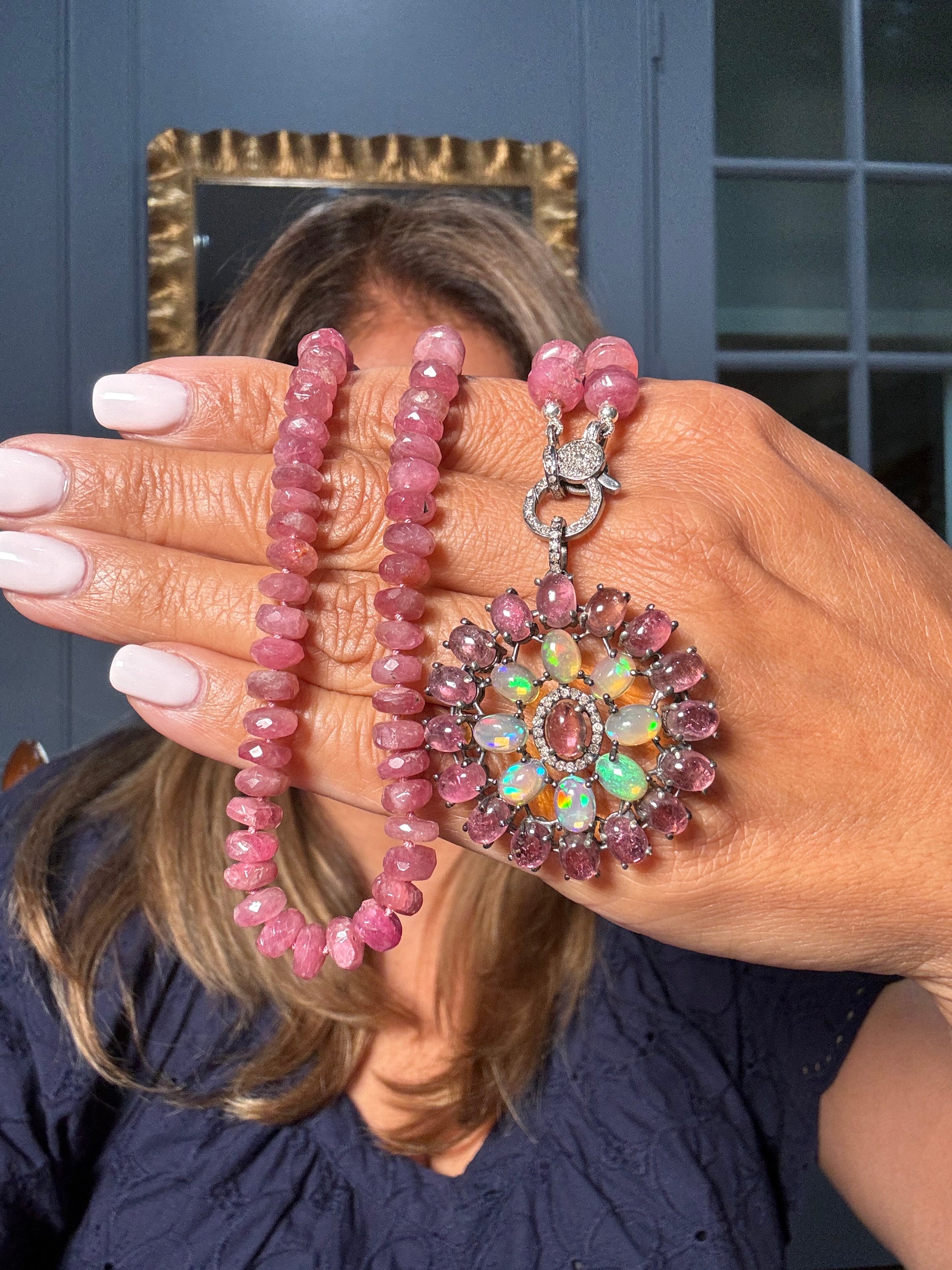 Pink tourmaline necklace paired with a floral medallion pendant of Ethiopian opals and faceted tourmalines, framed in pavé diamonds — a radiant one-of-a-kind Ulka Rocks statement piece.