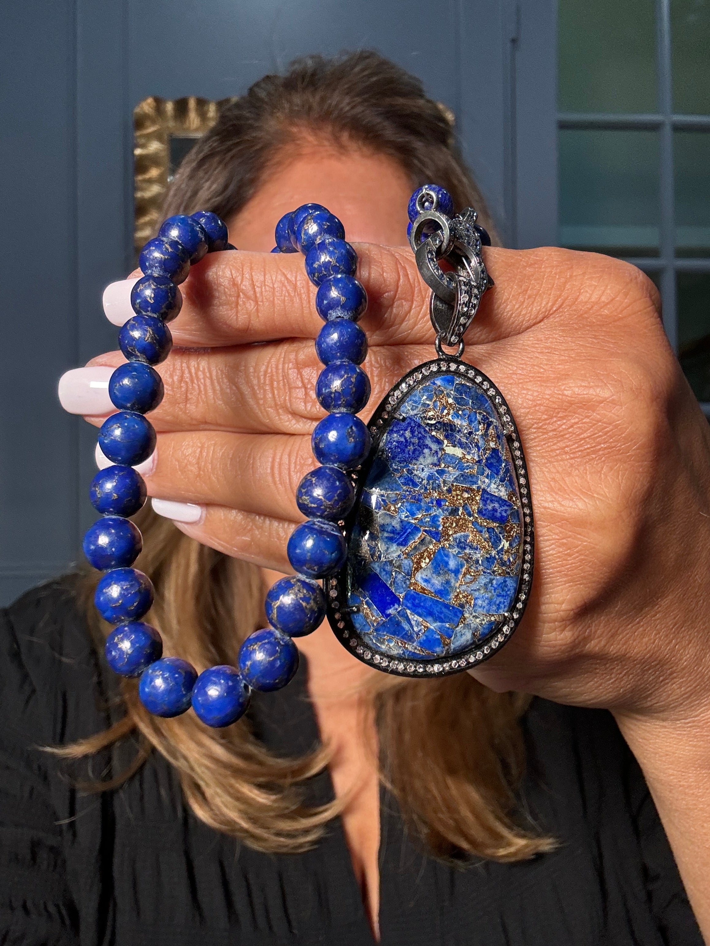 Rich blue lapis necklace paired with a mosaic lapis and pyrite pendant framed in diamonds. Features sterling silver and a diamond clasp. Ulka Rocks exclusive.