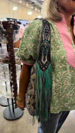 Heritage Brand bag No. 3818 worn on the shoulder at the Dallas show, steer skull strap