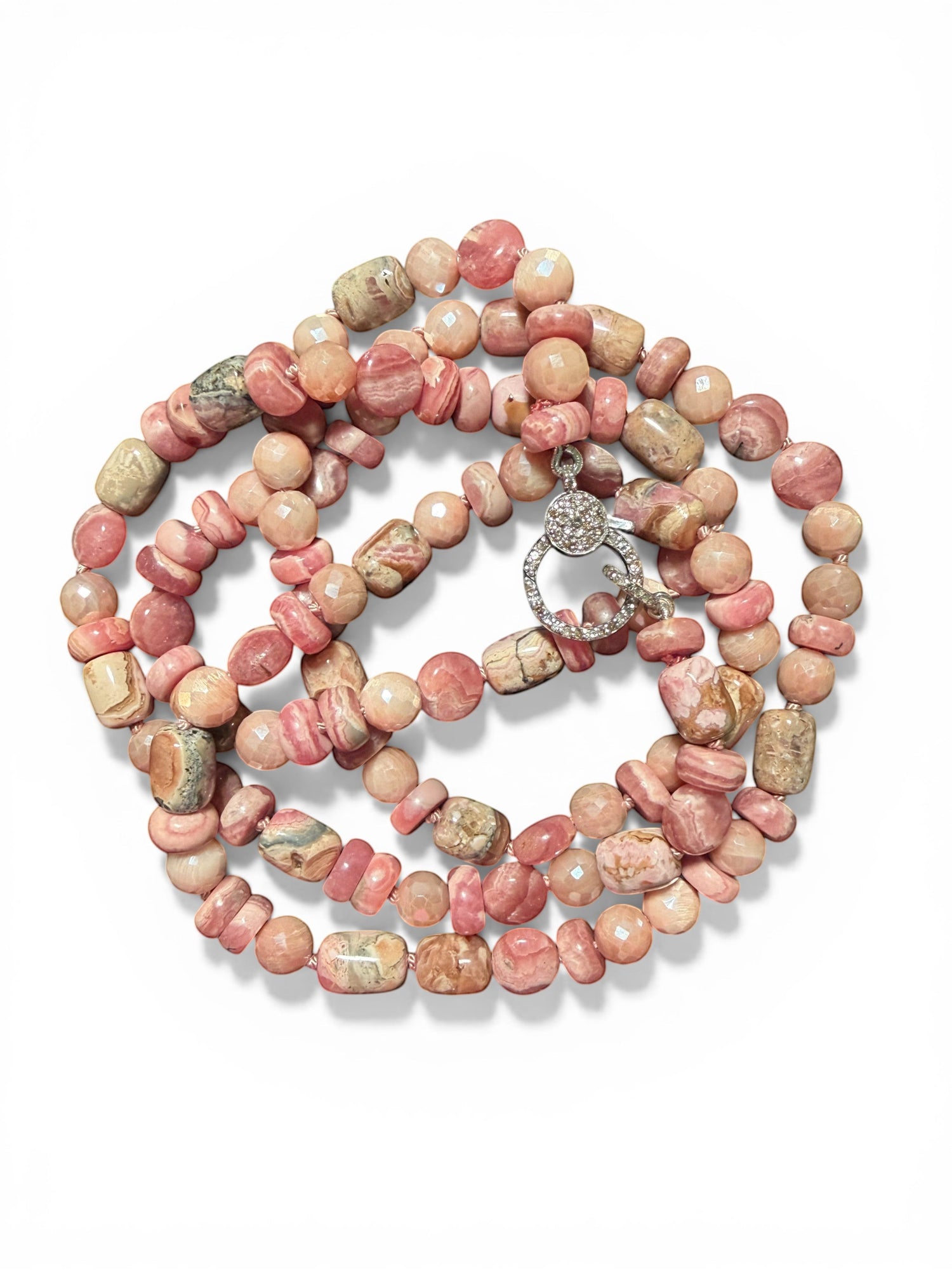 35-inch rhodochrosite and peach moonstone necklace with sterling silver diamond clasp arranged in circular pattern on white background