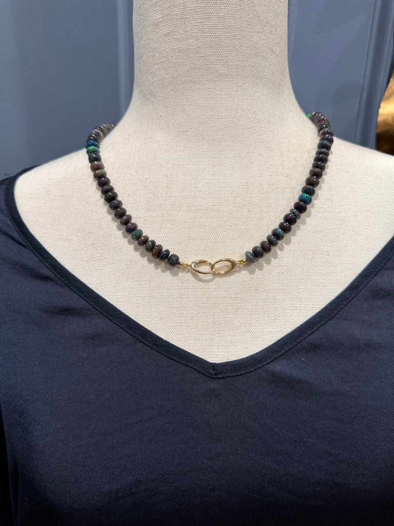 Australian black opal bead necklace styled with 14K gold handcuff clasp