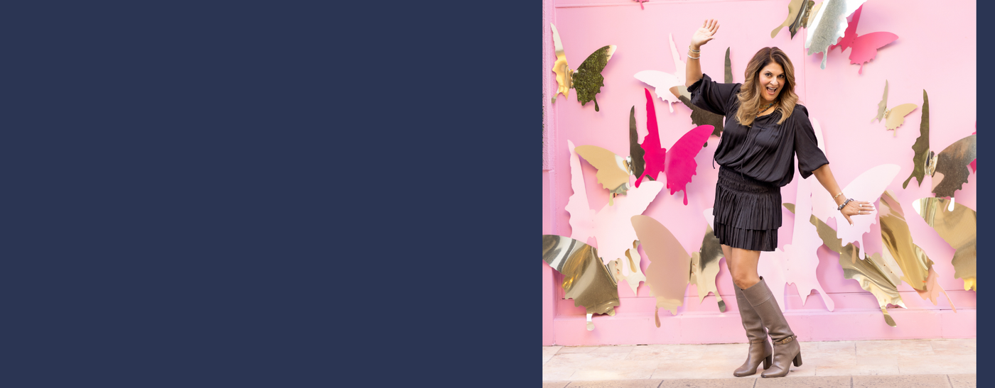 Ulka celebrating in front of a butterfly wall