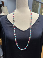 Detail view of Diamond and Pearl and Topaz necklace showing gemstone color and texture