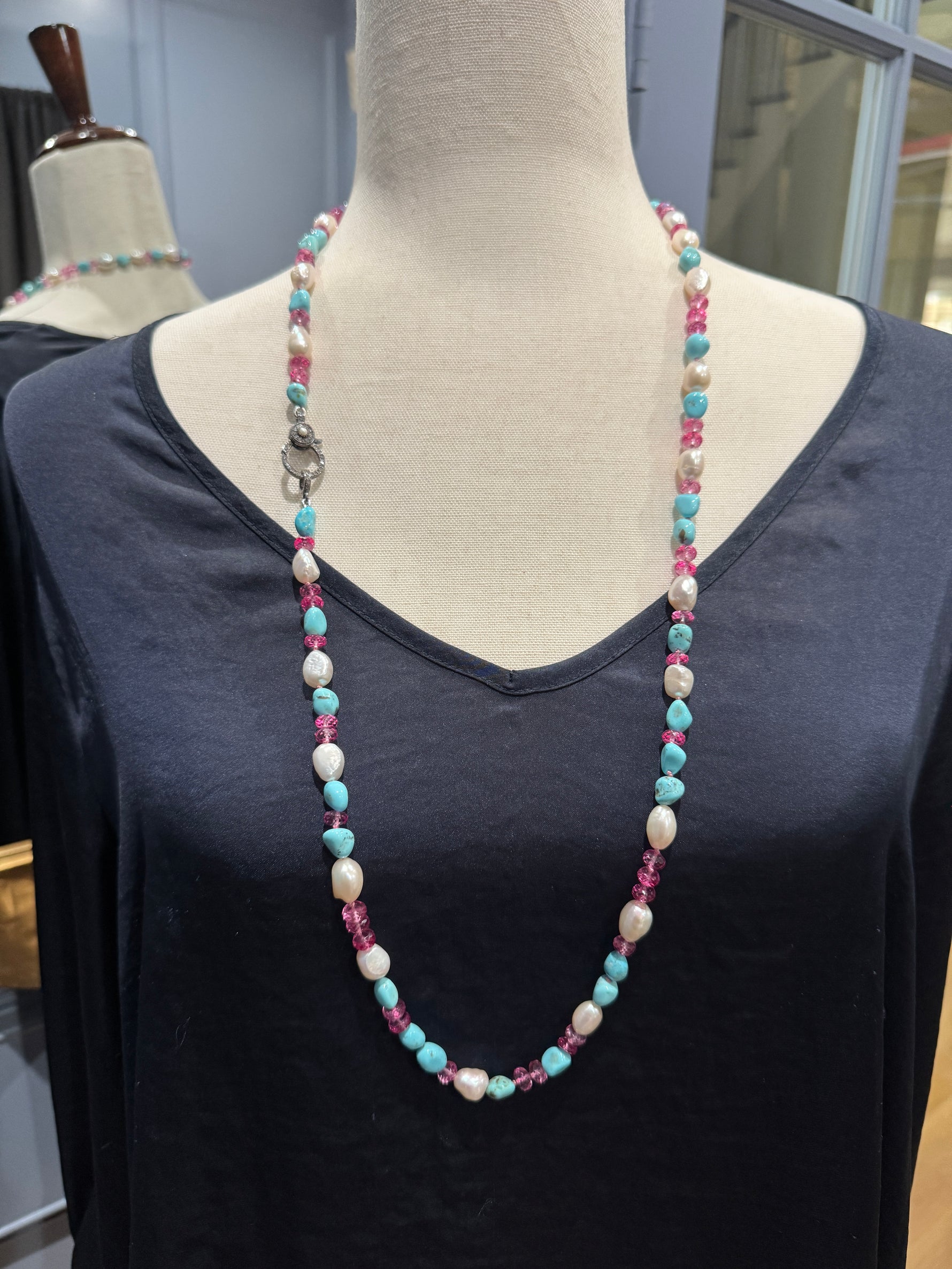 Detail view of Diamond and Pearl and Topaz necklace showing gemstone color and texture