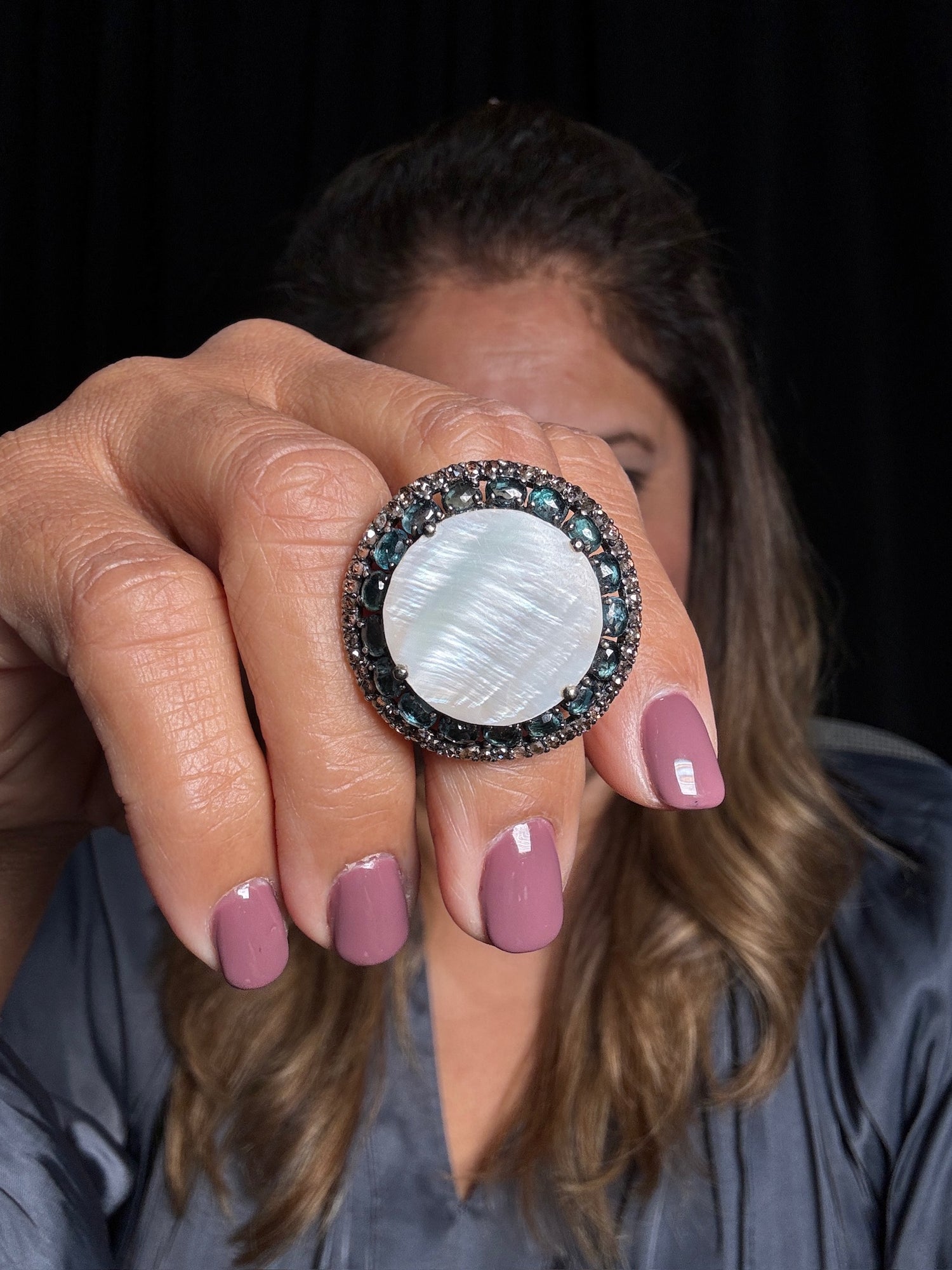 Detail view of London Blue Topaz and Mother of Pearl and Diamond ring showing gemstone color and texture