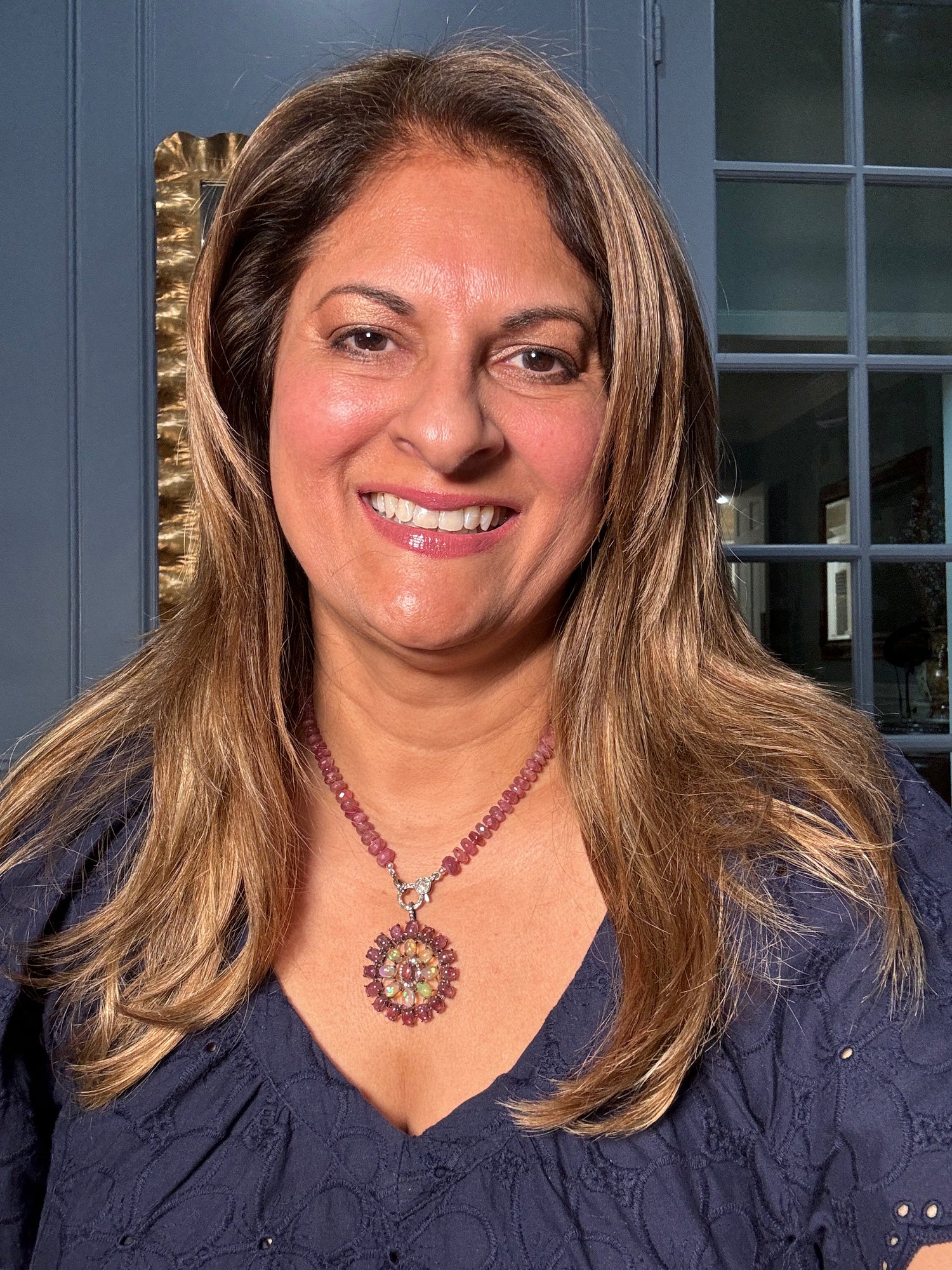 Woman wearing 18.5-inch pink tourmaline necklace with colorful opal and pink tourmaline medallion pendant, showcasing radiant gemstone colors