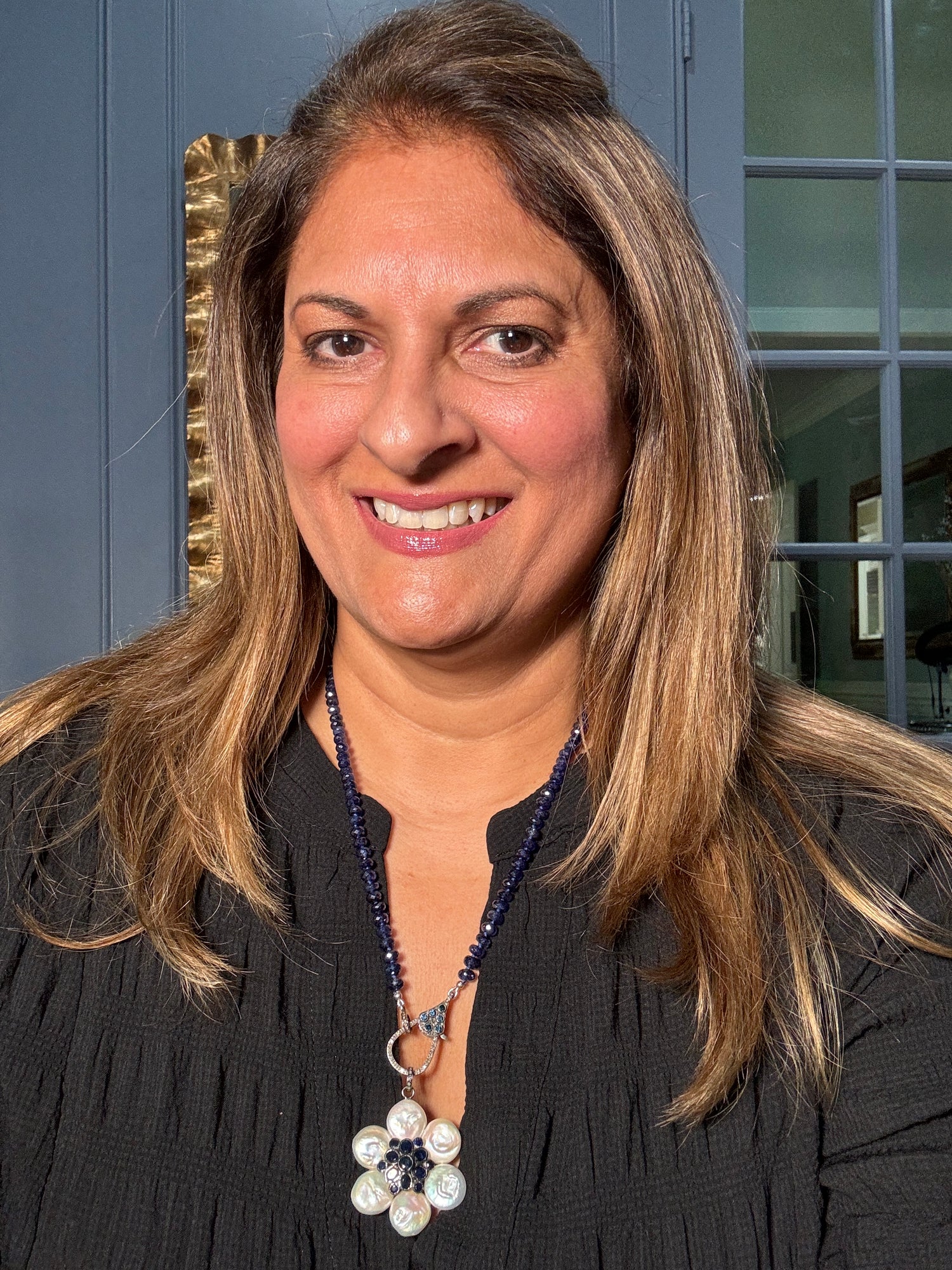 Detail view of Diamond and Pearl and Sapphire necklace pendant combo showing gemstone color and texture