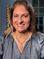 Woman wearing 18-inch aquamarine and morganite necklace with rose quartz heart pendant, showcasing the blue and pink gemstone beads in natural lighting.