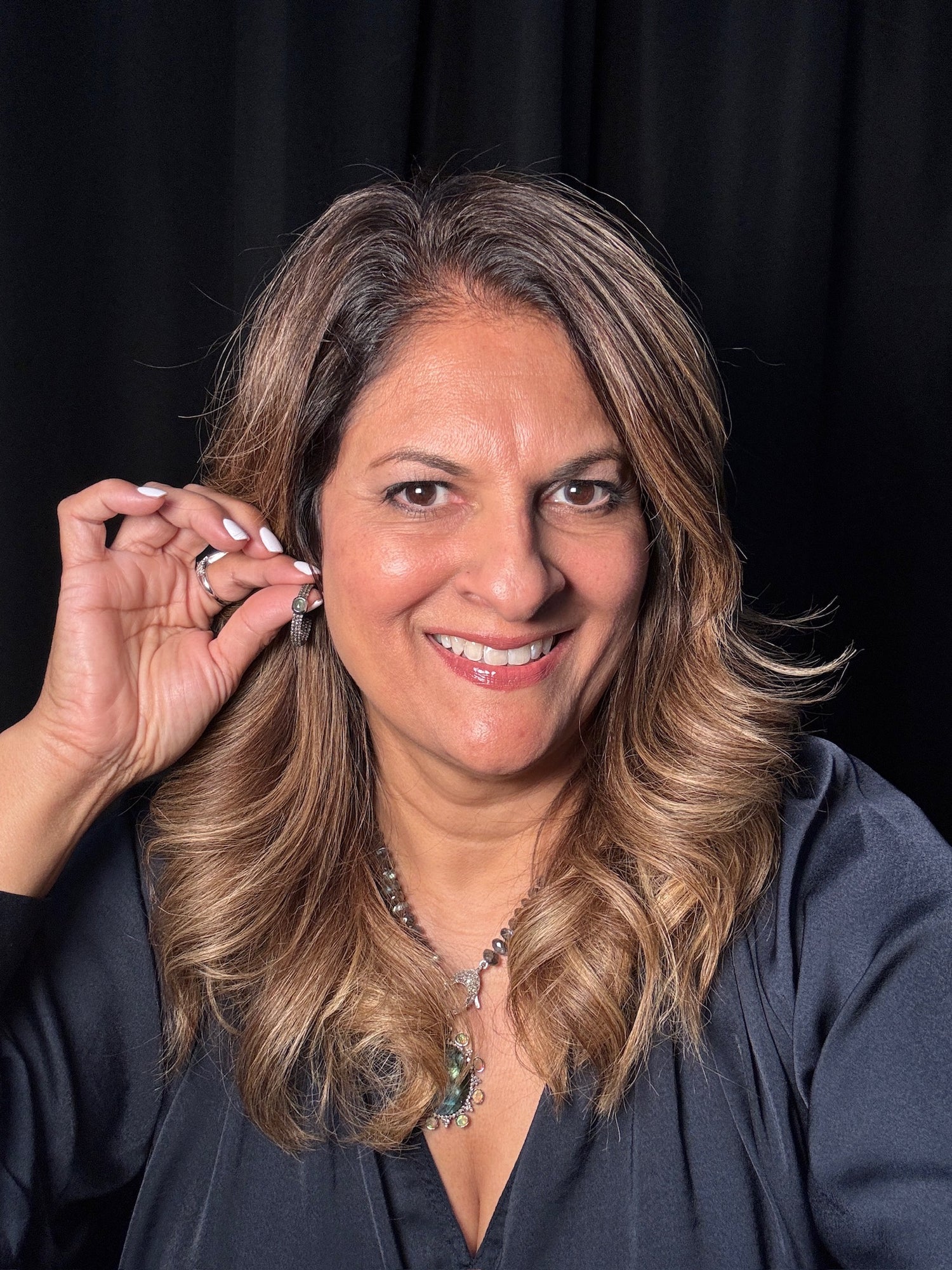 Detail view of Diamond and Emerald earrings showing gemstone color and texture