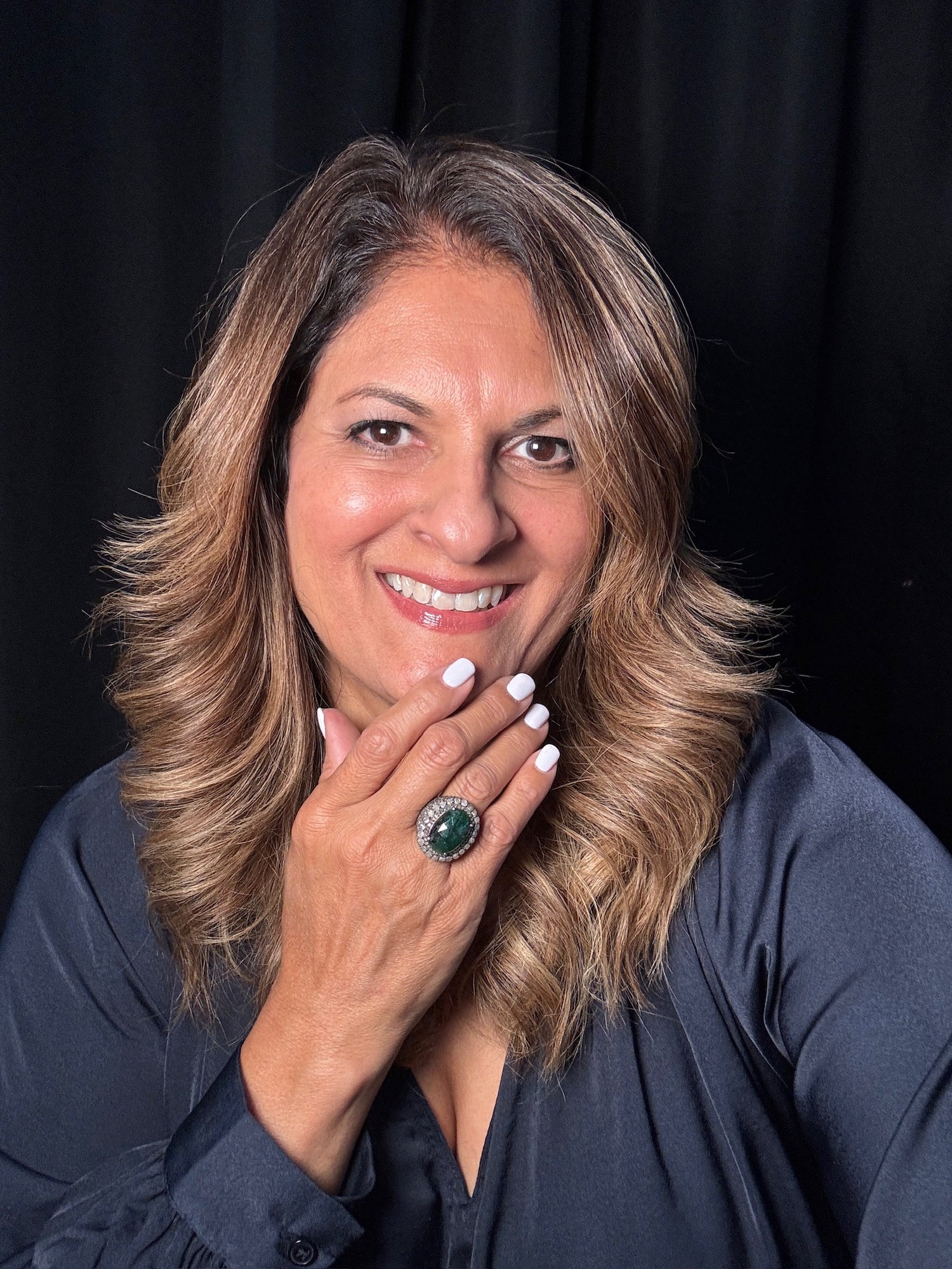 Detail view of Diamond and Emerald ring showing gemstone color and texture
