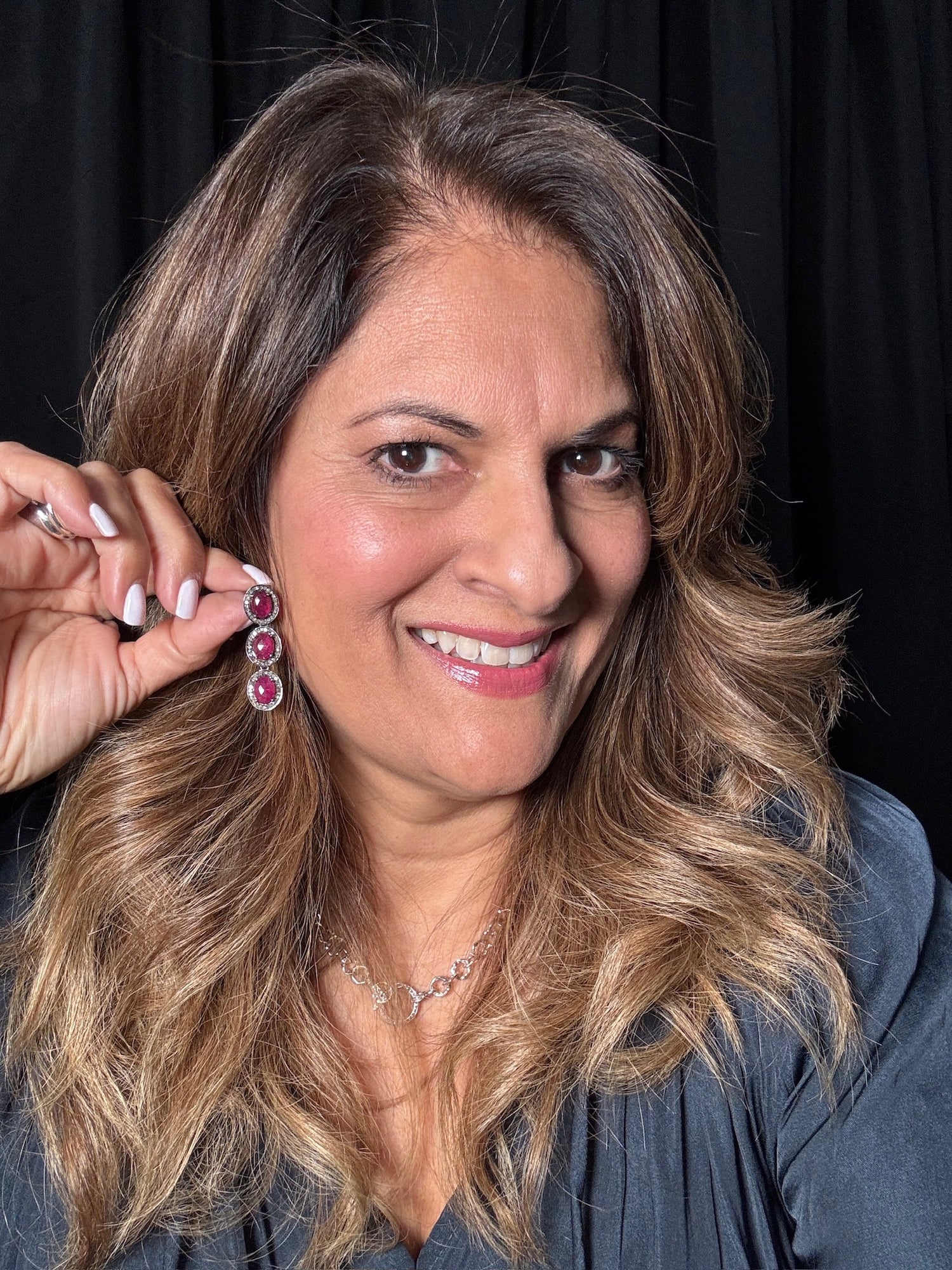 Detail view of Diamond and Ruby earrings showing gemstone color and texture
