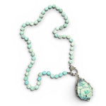 Larimar beaded necklace with a large teardrop pendant on a white background