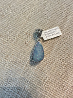 Elongated teardrop Australian opal pendant with blue-gray coloring and colorful flashes, set in minimalist sterling silver bezel mounting