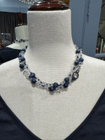 Close-up view of 36-inch beaded necklace with alternating blue kyanite rounds and faceted clear Herkimer diamonds draped around mannequin neck showing luxurious sparkle.
