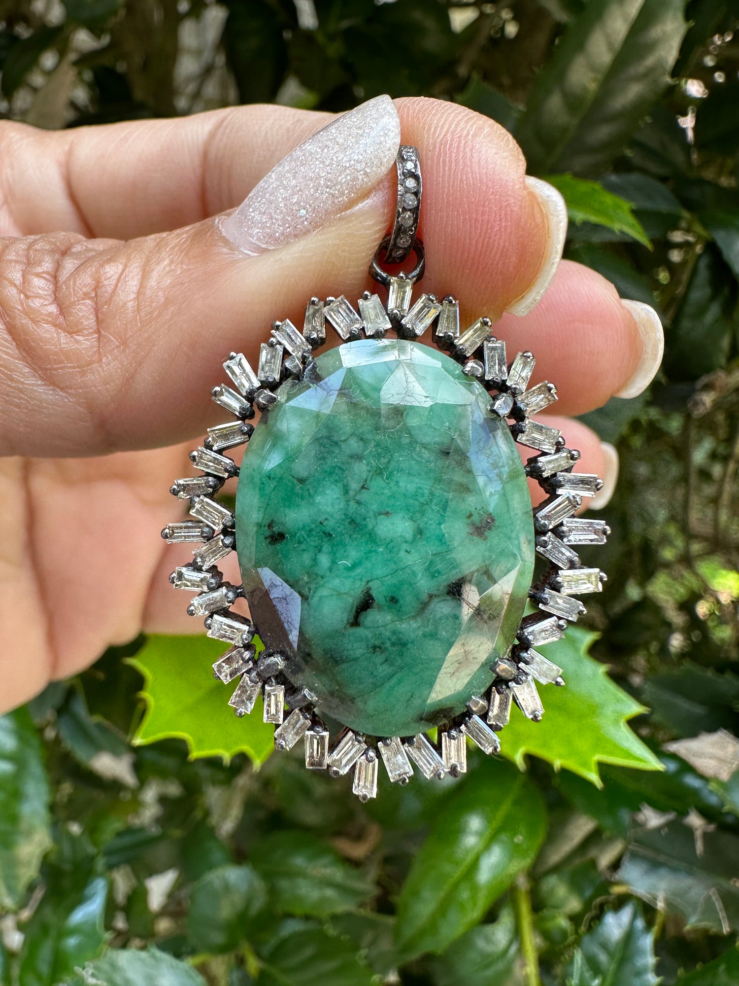 Detail view of Diamond and Emerald necklace pendant combo showing gemstone color and texture