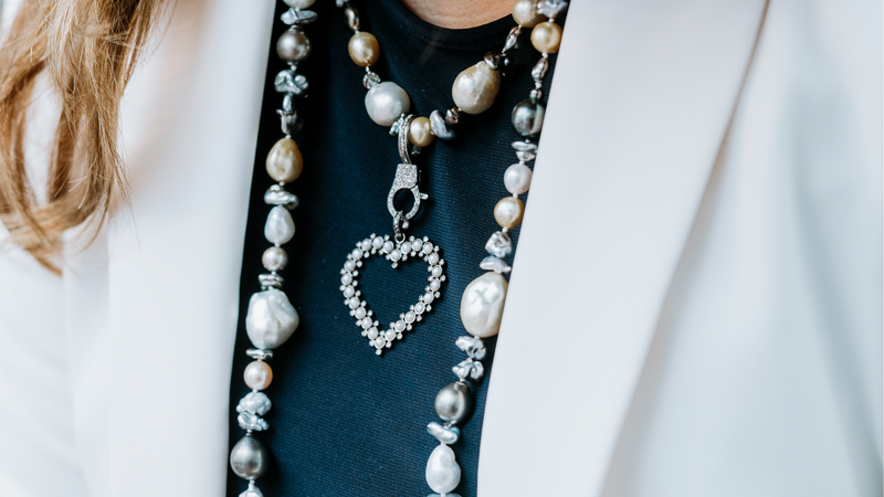 Woman wearing layered luxury pearls with a pendant
