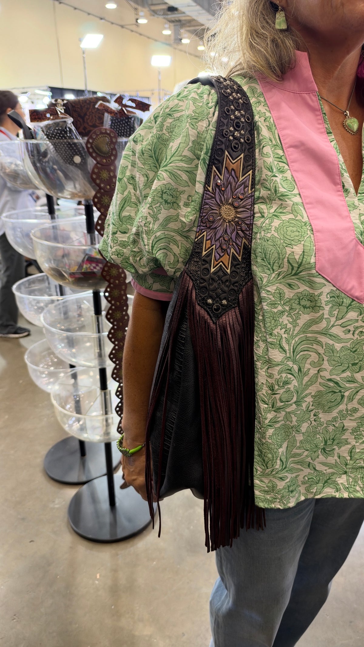 Heritage Brand grey lizard purse with wine fringe worn on the shoulder at the Dallas show