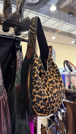 Heritage Brand bag No. 3054, leopard hair-on-hide side with black fringe and tooled rose strap