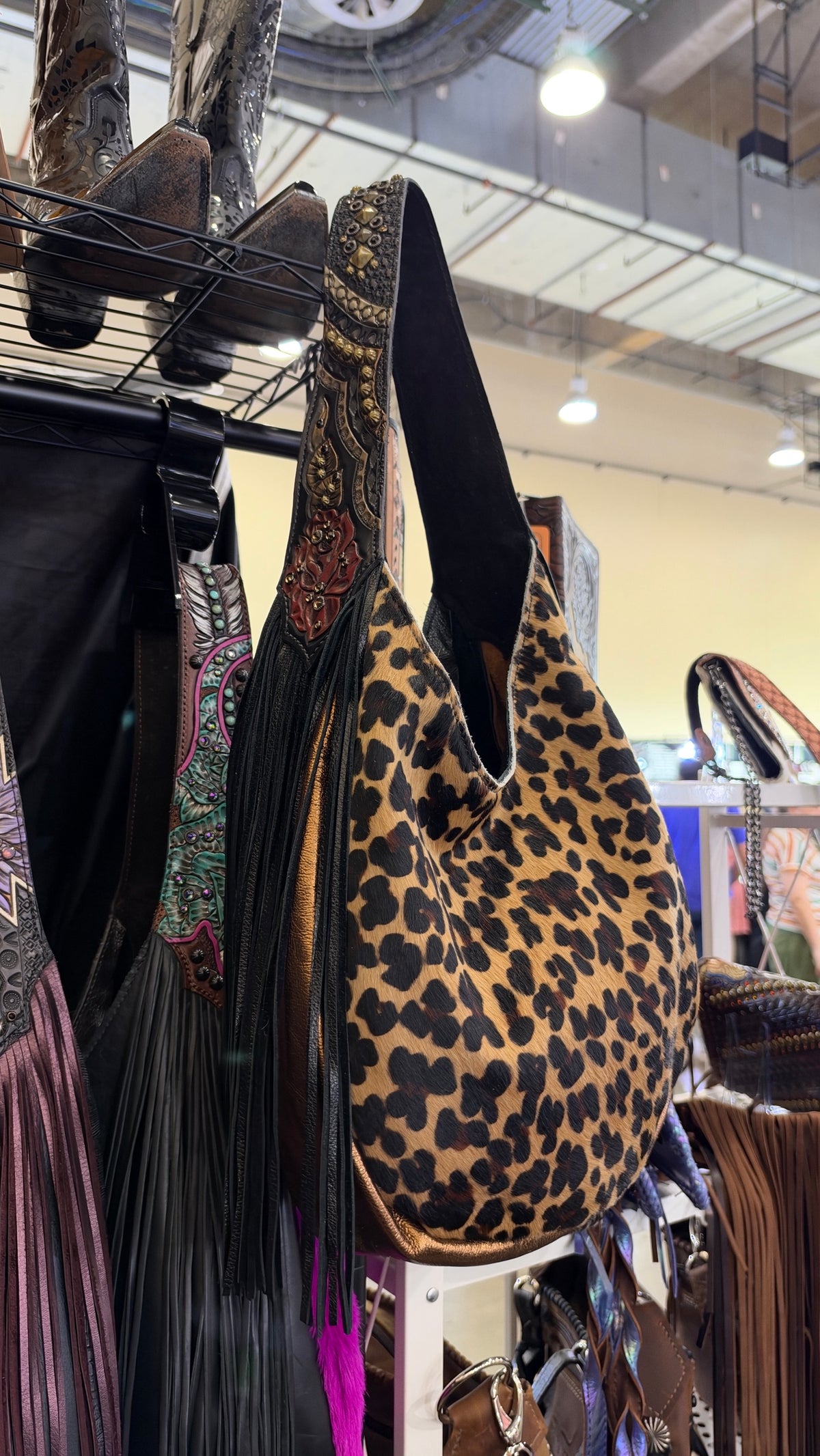 Heritage Brand bag No. 3054, leopard hair-on-hide side with black fringe and tooled rose strap