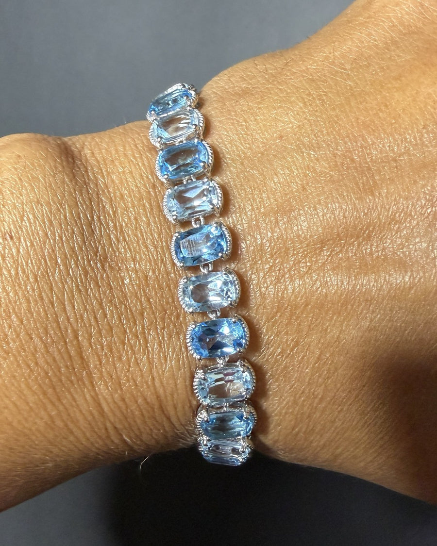 Cushion-cut blue topaz in every shade of sky, set link by link in sterling silver