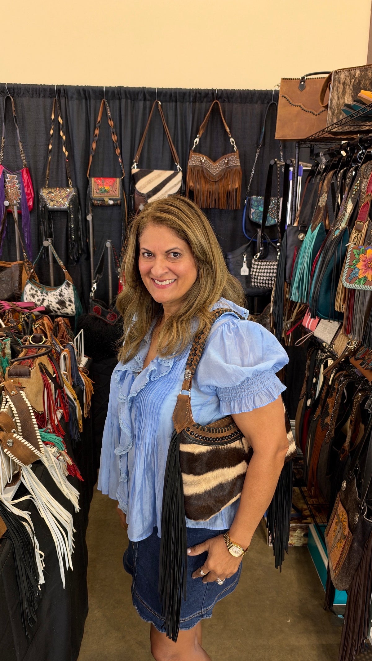 Zebra hide fringe bag worn on the shoulder at the Dallas show