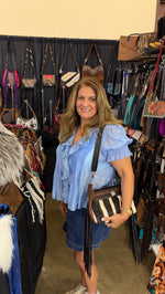 Zebra hide crossbody bag worn at the Dallas show