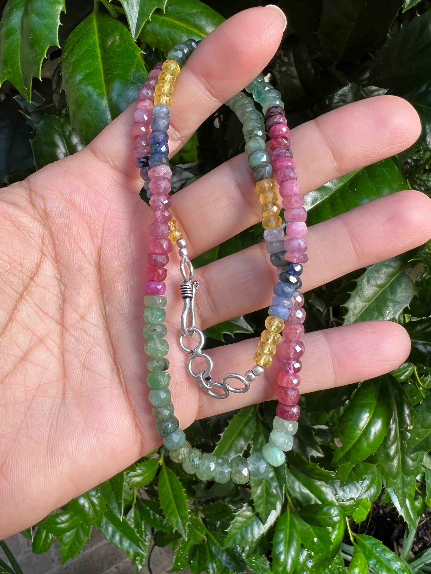 Detail view of Emerald and Ruby and Sapphire necklace showing gemstone color and texture