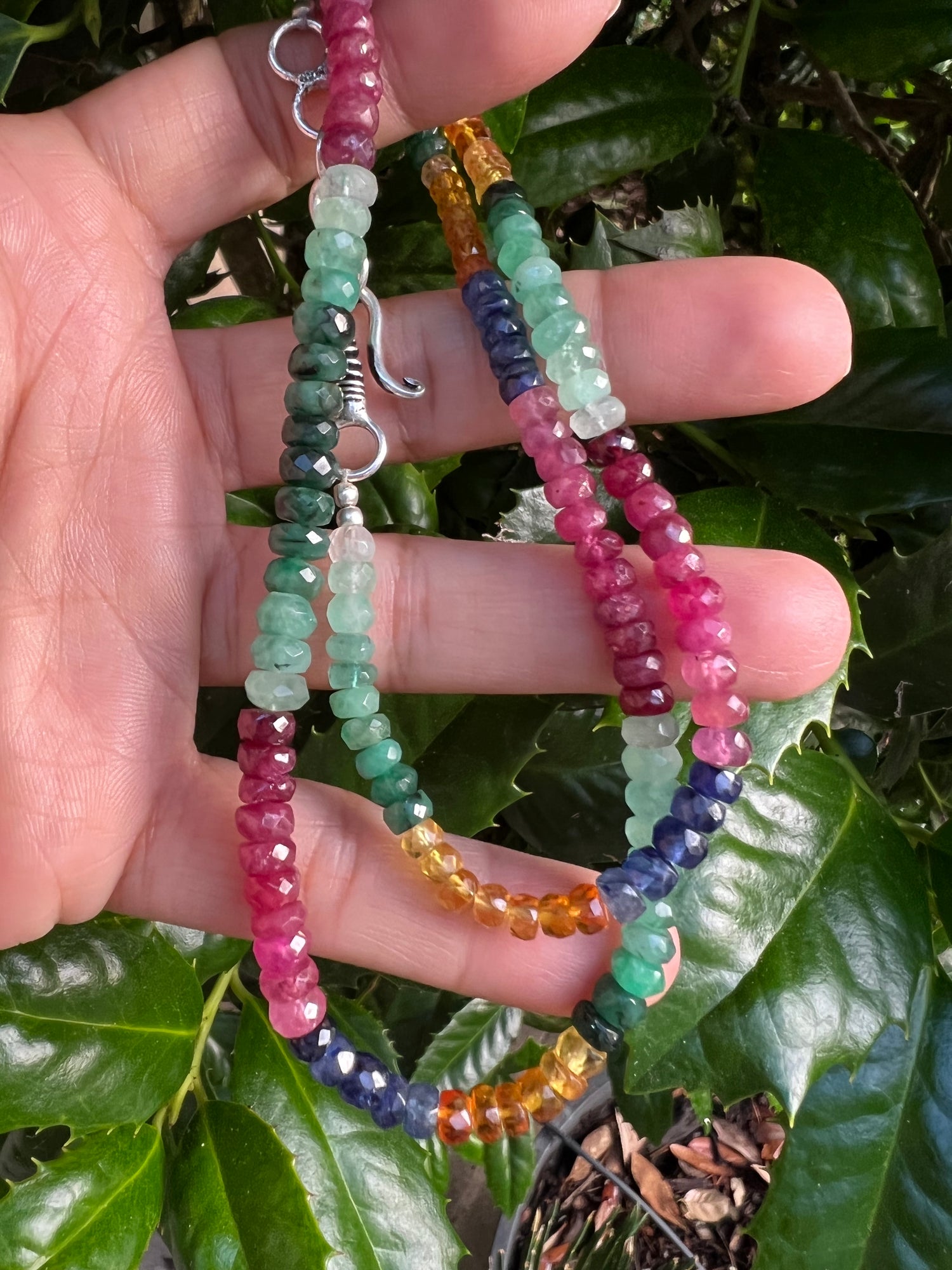 Detail view of Emerald and Ruby and Sapphire necklace showing gemstone color and texture