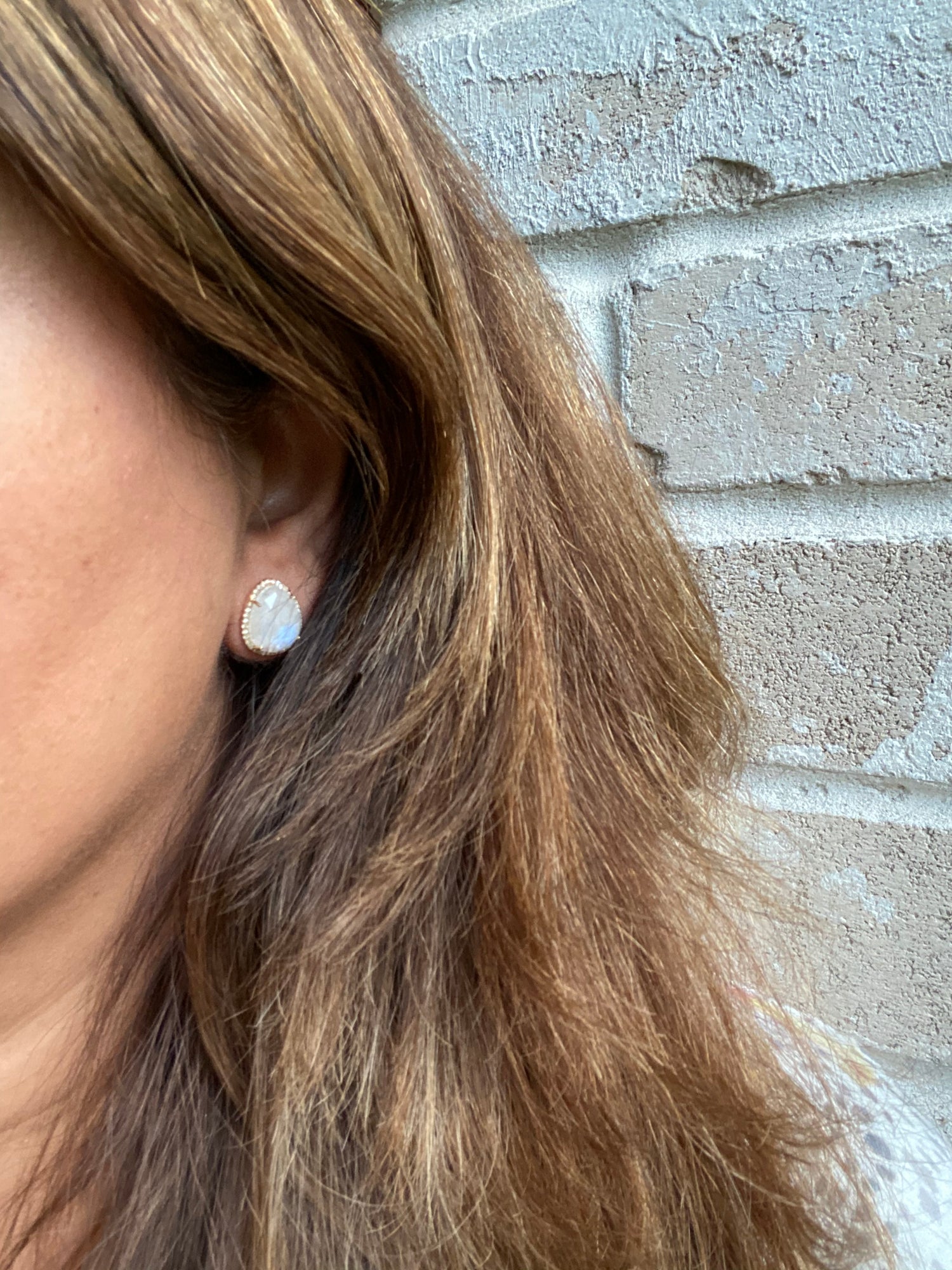 Detail view of Diamond and Moonstone earrings showing gemstone color and texture