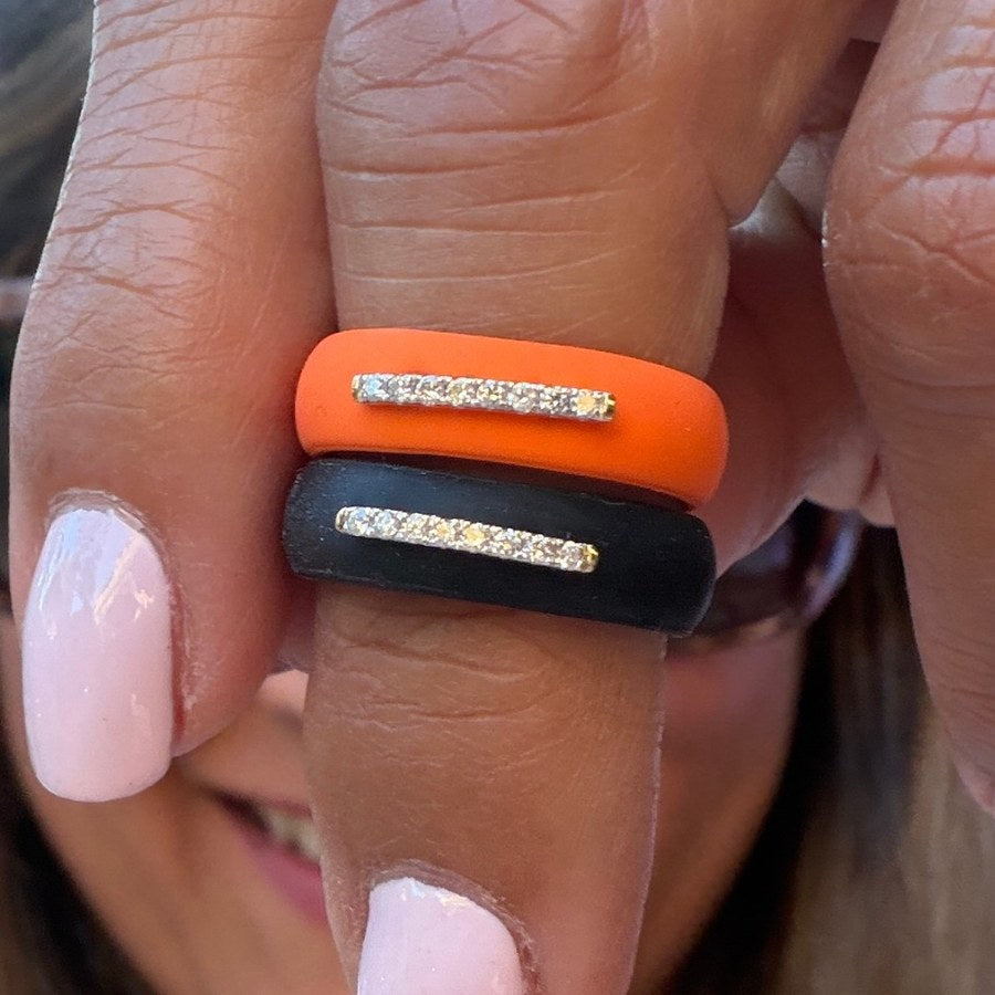 The diamond bar on orange and black silicone bands